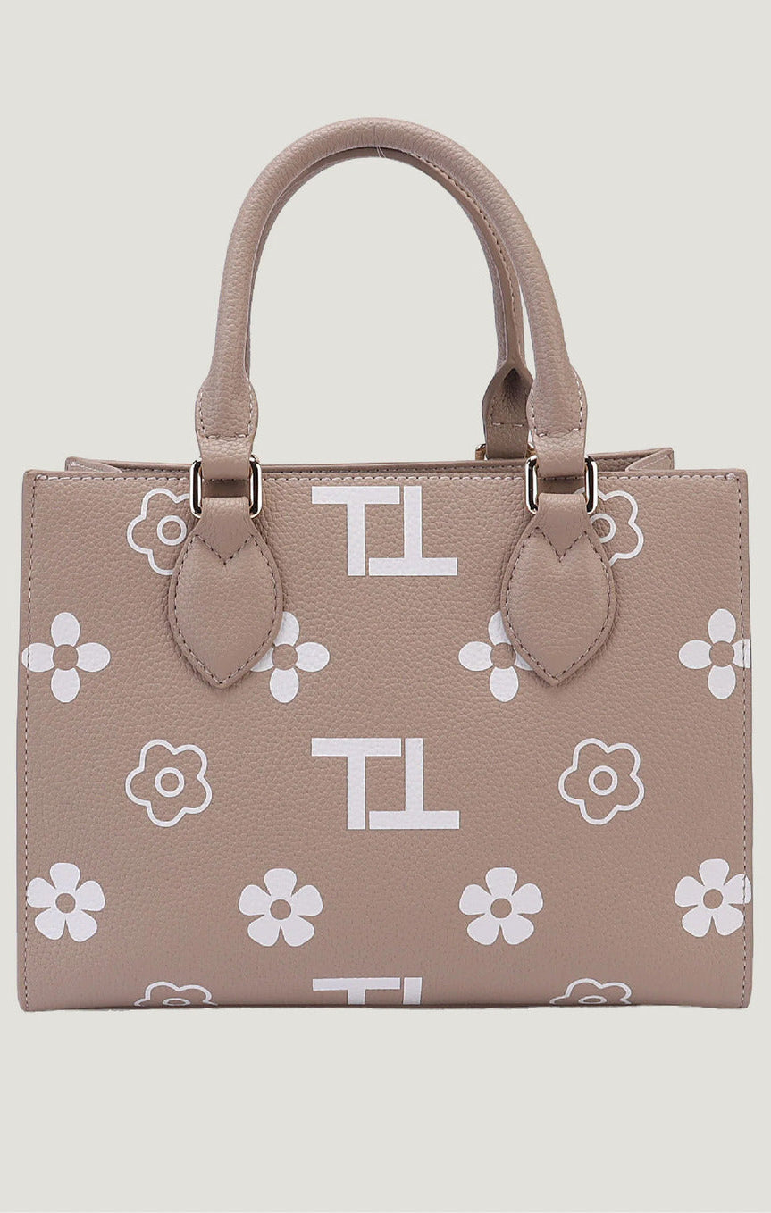 Beige handbag with white floral and letter pattern on a light gray background